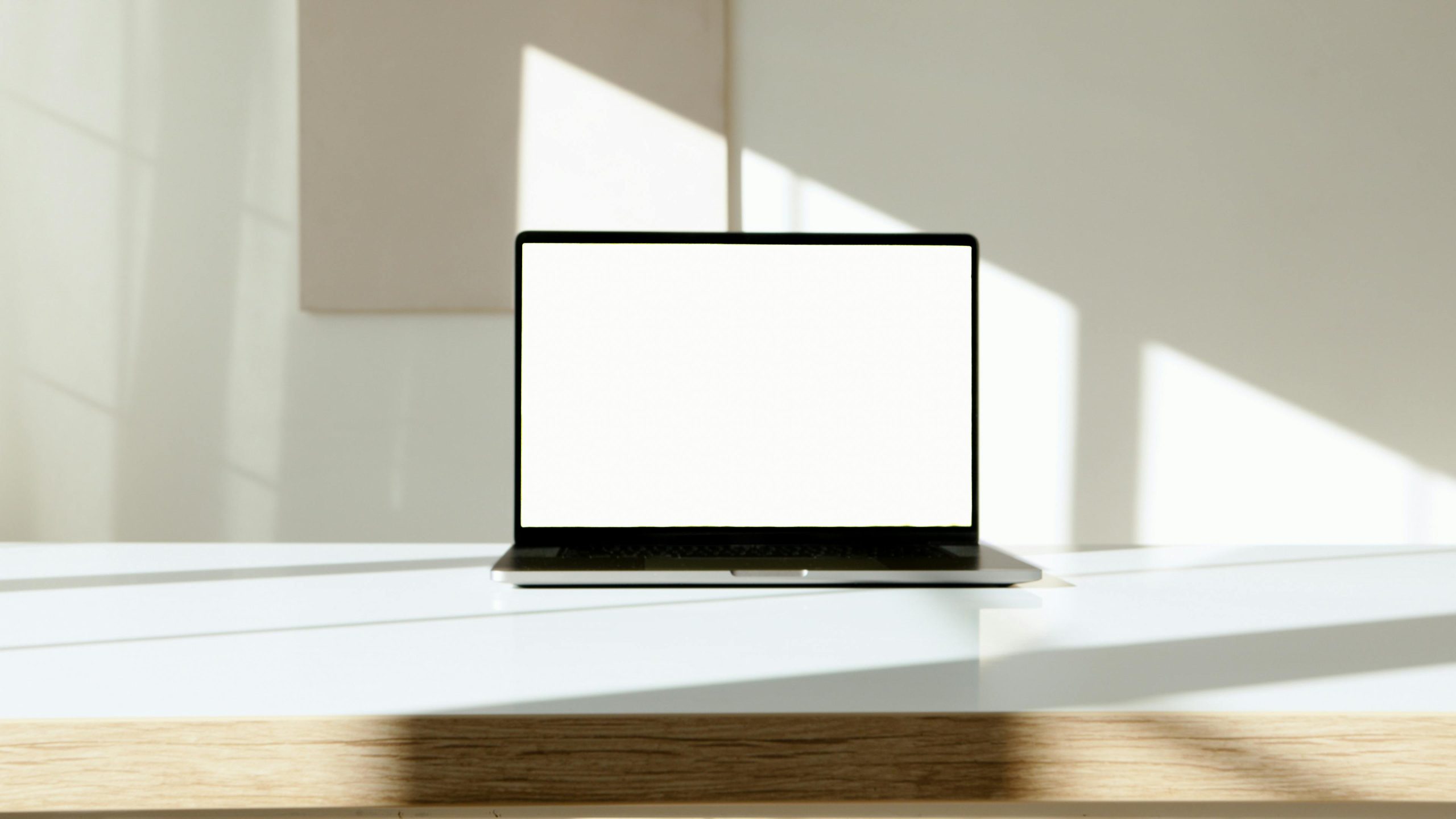 A laptop with a blank screen displayed on a stylish desk, ready for customization.